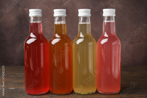 Delicious kombucha in glass bottles on wooden table