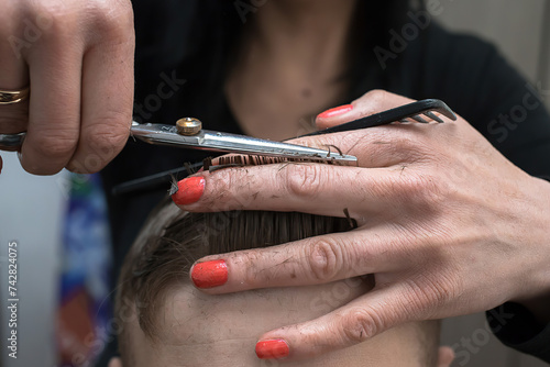 hairdresser’s hands with scissors, close up
