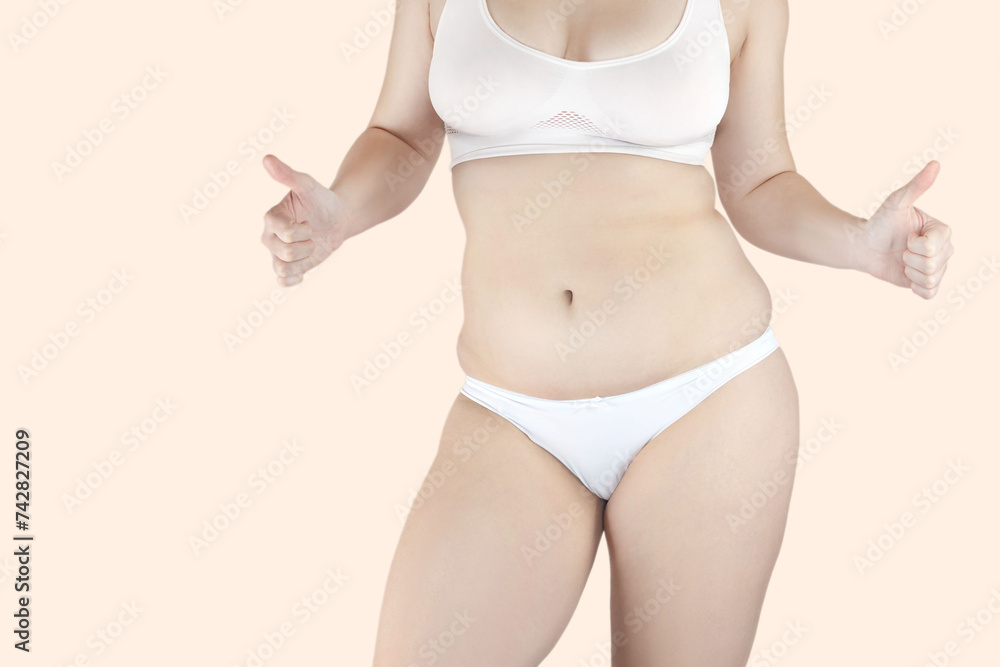 Body positive concept. A woman with excess belly fat loves her body. She is happy. Body positive concept. A woman with excess belly fat loves her body. She is happy.