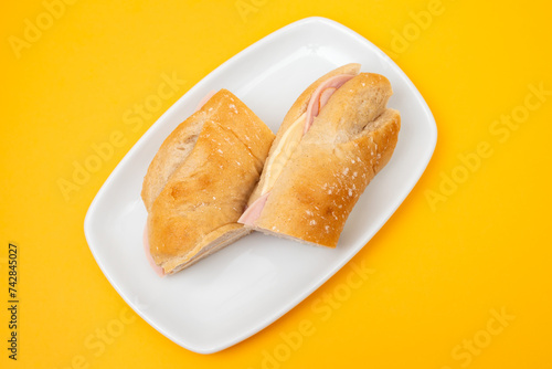 a spanish rosca de jamon serrano, ham sandwich, on a white plate