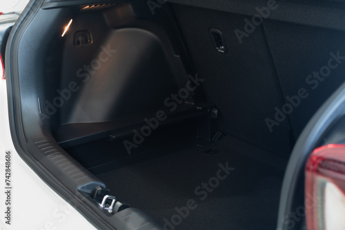 Luggage compartment of a modern vehicle close-up with light lamp photo