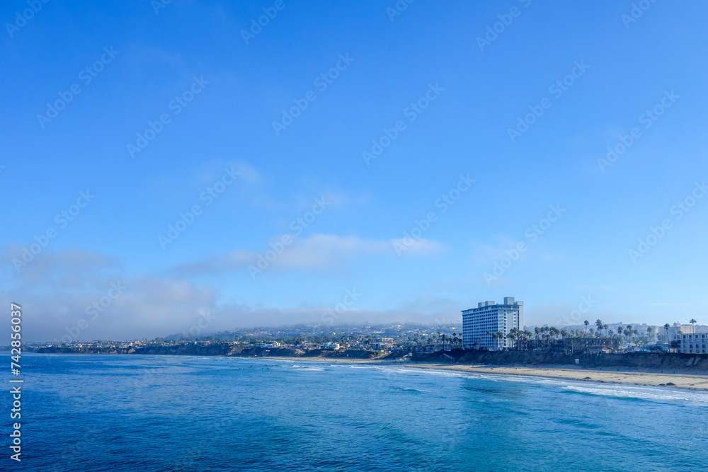 Early morning at Pacific Beach surrounded by seaside hotels and recreational areas as seen from Crystal Pier in San Diego, Southern California