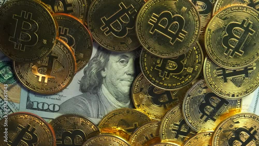 Concept of competition between digital money bitcoin and dollar. Crypto currency coins on US 100 dollar bills.