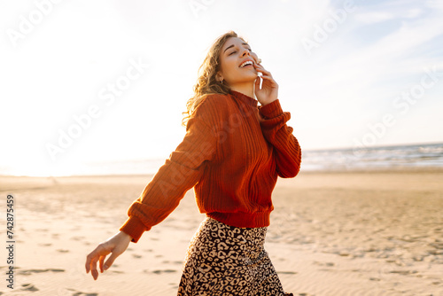 Portrait of the beautiful woman at the windy spring day relaxing on coast. Travel, weekend, relax and lifestyle concept. photo