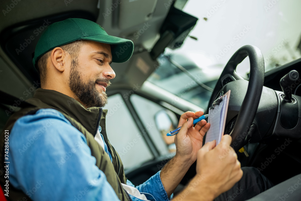 Young handsome man working in towing service and driving his truck. Young handsome man working in towing service and driving his truck.