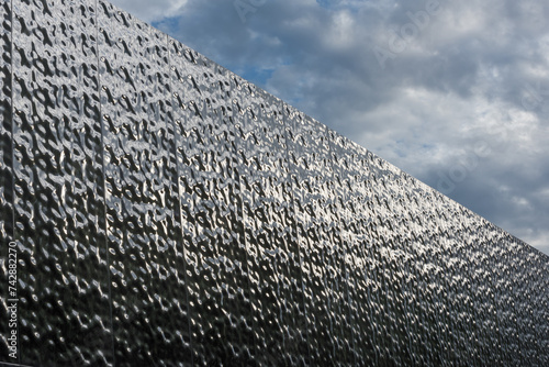 Metal building facades that mimic the texture of rippling water surfaces