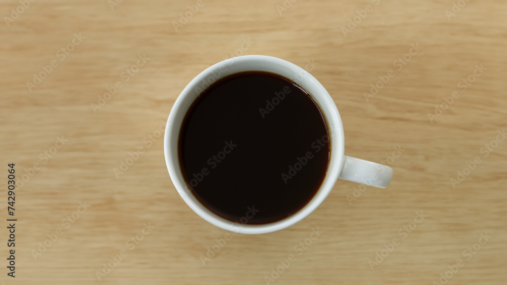 white cup full of black coffee on a wooden table white cup full of black coffee on a wooden table