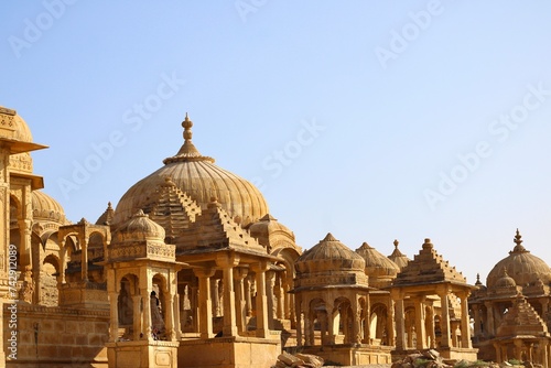 he regal cenotaphs, also known as Jaisalmer Chhatris, stand majestically at Bada Bagh in Jaisalmer, Rajasthan, India photo