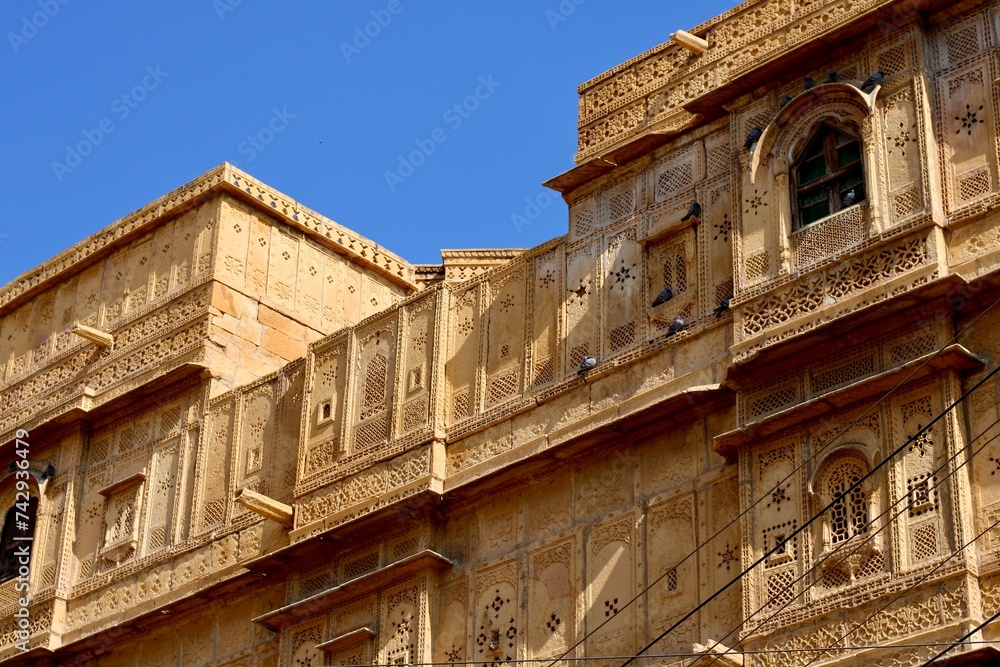 Floral-style Rajasthani haveli carving patterns adorn an old building in Jaisalmer, Rajasthan, India