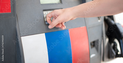 Female worker choose the type of oil gas at pump gas station photo