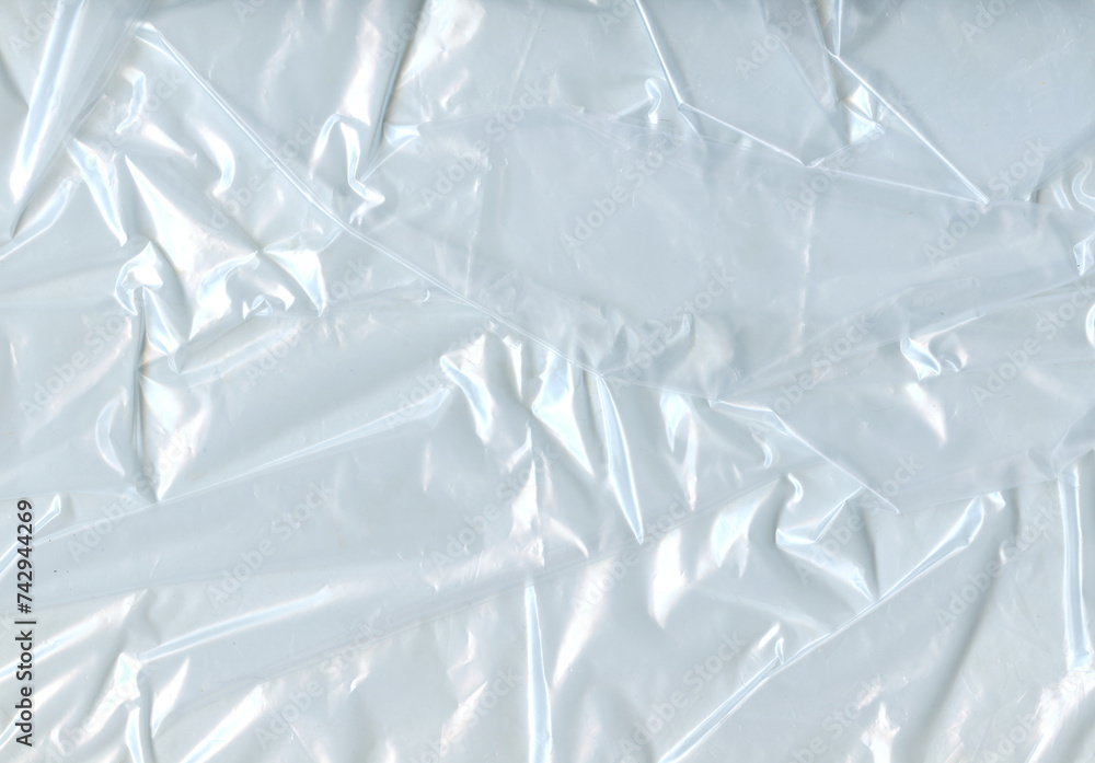 Crumpled Plastic Bag Surface Texture. Cellophane Background for design. The texture of Stretched Polyethylene. Crumpled Wrapping Material. Crumpled Plastic Bag Surface Texture. Cellophane Background for design. The texture of Stretched Polyethylene. Crumpled Wrapping Material.