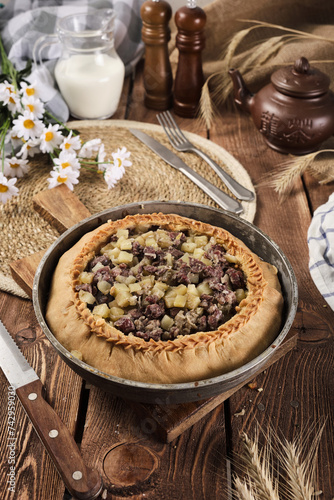 Tatar national pie balish on a wooden background