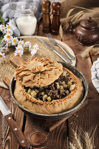 Tatar national pie balish on a wooden background