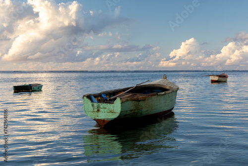 View of small fishing boats on Balaclava Public Beach at sunset, Mauritius.