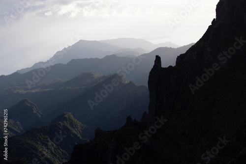View of silhouette mountain peaks during sunrise, near Pico de Areeiro, Madeira Island, Portugal photo