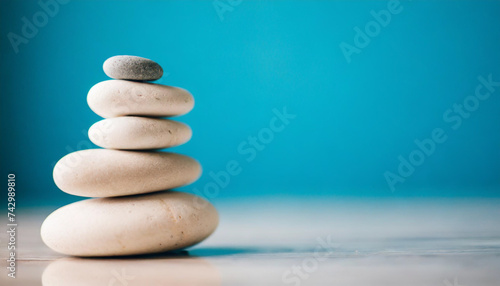 Single white sea pebble stacked against serene light blue backdrop  symbolizing balance and tranquility. Ideal for mindfulness concepts