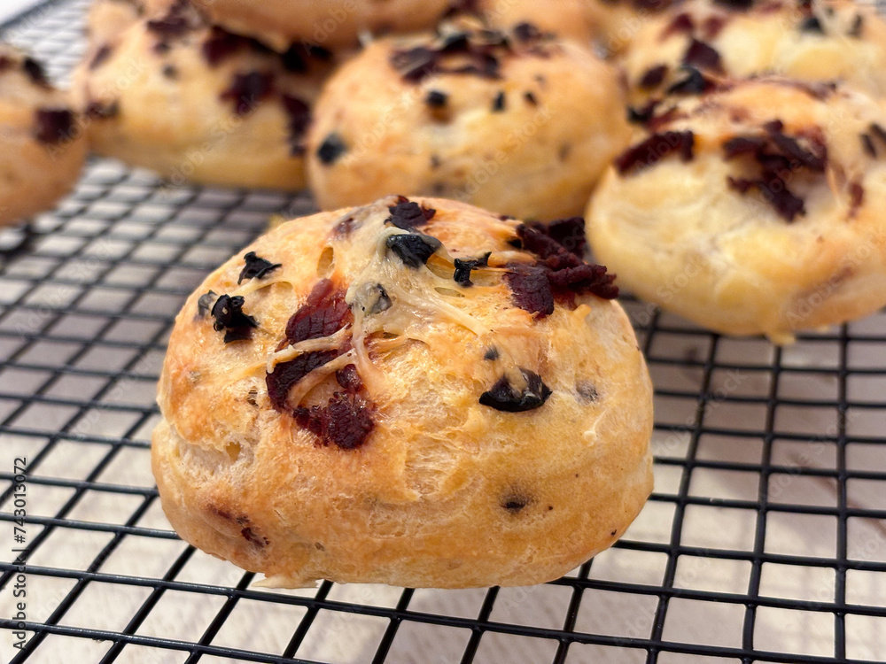 Close up of French savory choux dough cheese puff filled with crispy fried bacon in a baking tray. The pastry  know as typically of Burgundy region take as an appetizer. 