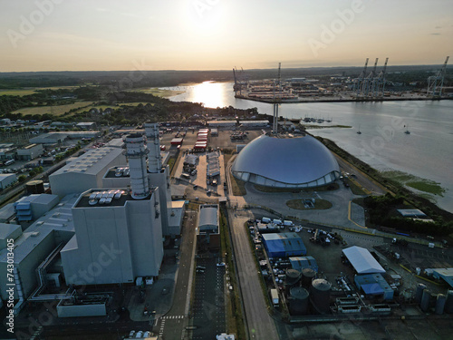 Aerial view of sunset and gas-fired Power Station in Marchwood, Hampshire, UK. Southampton container terminal at the distance.