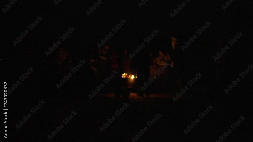 Berber musicians dancing and playing drums at night in the Mergouza Sahara desert around campfire long shot Berber musicians dancing and playing drums at night in the Mergouza Sahara desert around campfire long shot