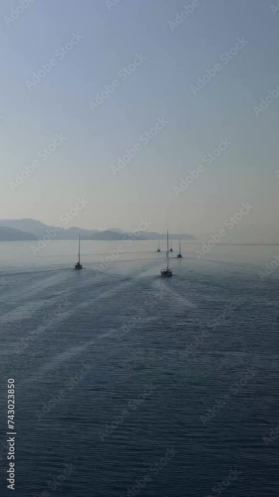 Group Of Sailboats With Deflated Sails Floating To Exit From Sea Bay Vertical Video
Group Of Sailboats With Deflated Sails Floating To Exit From Sea Bay Vertical Video