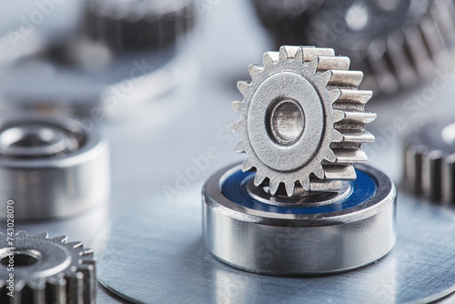 metal gears and bearings. Background with part of the mechanism.