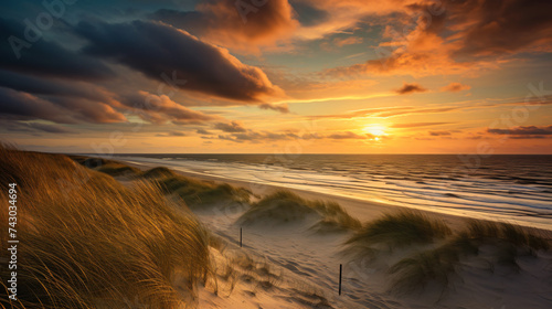 View from dune top over sunset in North Sea