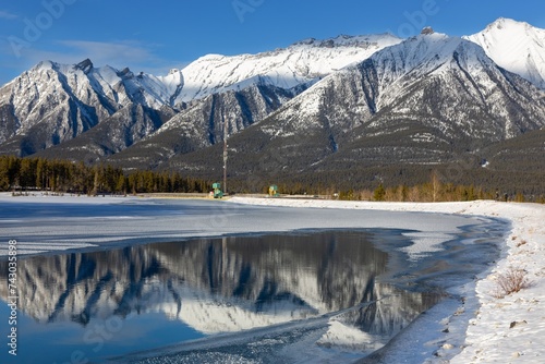 Snow Covered High Rocky Mountain Peaks Reflected in Calm Lake Water

Scenic Sunny Winter Day Landscape Panorama, Canadian Rocky Mountains Fairholme Range, Canmore Alberta Canada, Banff National Park photo