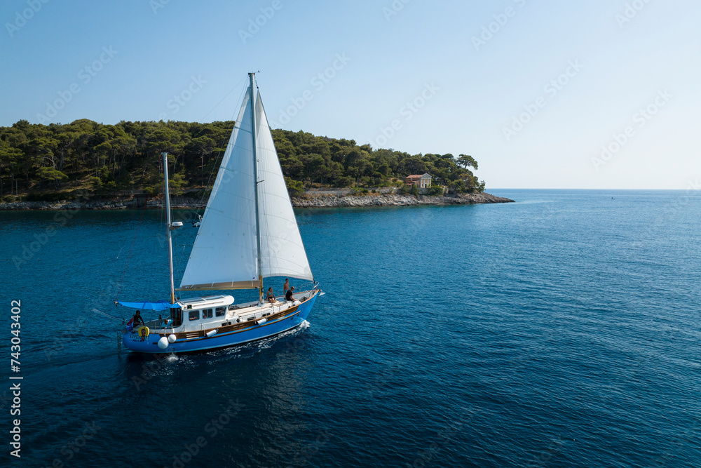 Aerial view of the Adriatic coast and sailboat in sunny summer day, Brac Island, Croatia. Aerial view of the Adriatic coast and sailboat in sunny summer day, Brac Island, Croatia.