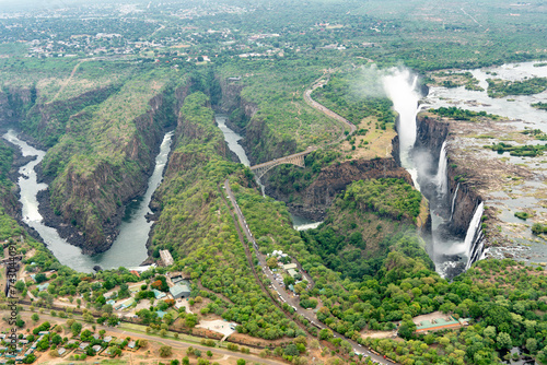 Aerial view of Victoria Falls in mist with greenery and transparent water, Victoria Falls, Zimbabwe. photo