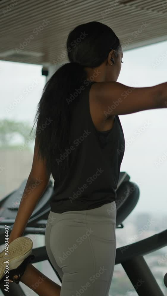 Black woman athlete stretching using ear phones in a skyscraper in Bangkok - Lifestyle concept Black woman athlete stretching using ear phones in a skyscraper in Bangkok - Lifestyle concept