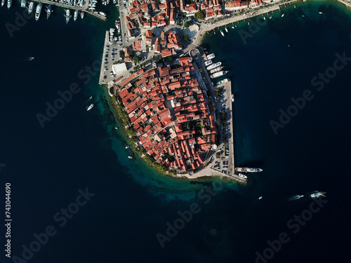 Aerial view of historic Korcula Island with red rooftops and marina, Croatia. photo