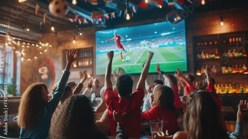 A crowd gathers around a large display device to share the excitement of a football game, building an entertaining event filled with fun and leisure. AIG41