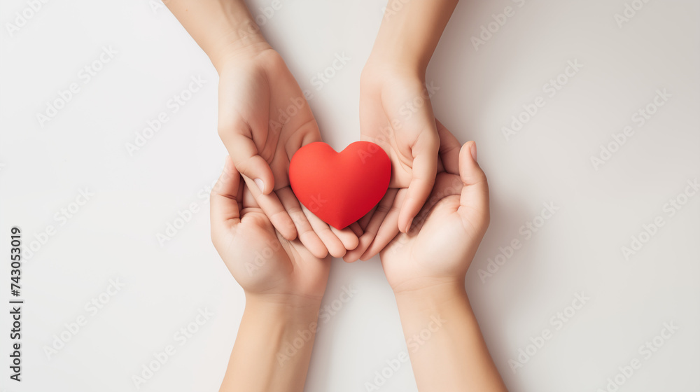 Family hands holding red heart, heart health insurance, organ donation, happy volunteer charity Family hands holding red heart, heart health insurance, organ donation, happy volunteer charity