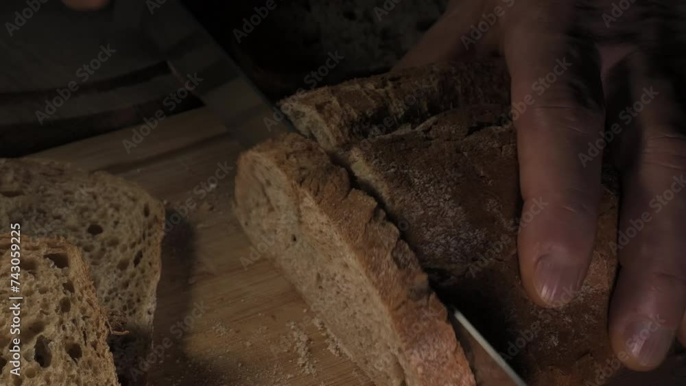 Cutting slice of homemade Crusty rye bread Cutting slice of homemade Crusty rye bread
