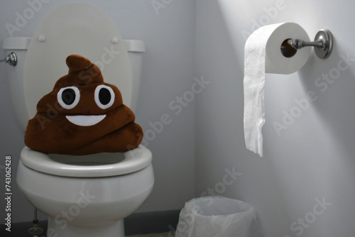 Concept of Gastrointestinal issues, diarrhea, constipation, stomach bug or flu - poop emoji in bathroom on toilet
