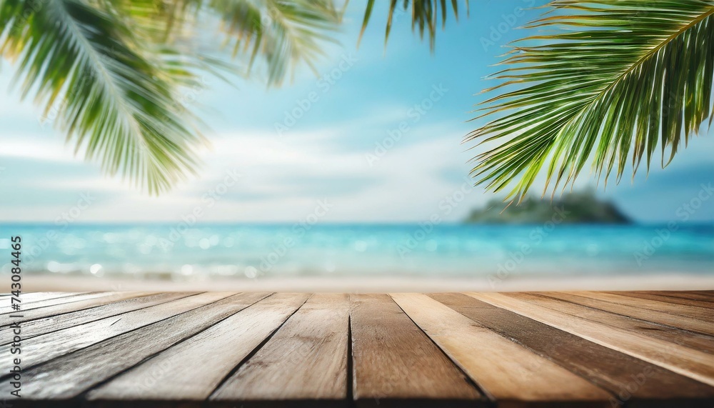 Top of wood table with seascape and palm leaves, blur bokeh light of calm sea and sky at tropical beach background Top of wood table with seascape and palm leaves, blur bokeh light of calm sea and sky at tropical beach background