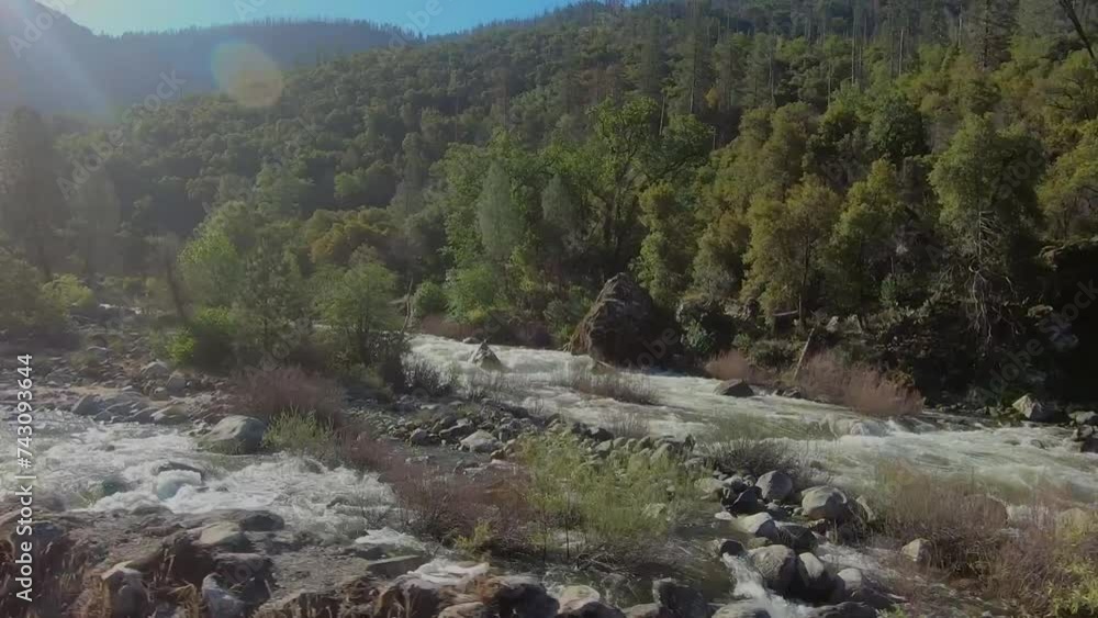 Driving along the mighty Merced river full, and raging Driving along the mighty Merced river full, and raging