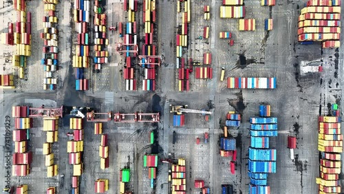 containers, cargo ships and loading cranes in port photo