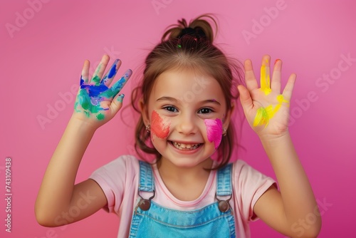 Child showing hands painted in colorful paints