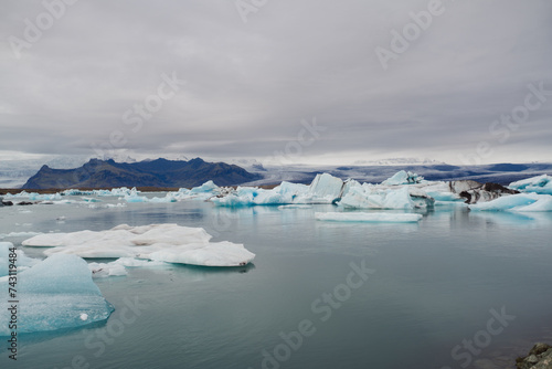 Traveling and exploring Iceland landscapes and famous places. Autumn tourism by Atlantic ocean and mountains. Outdoor views on beautiful cliffs and travel destinations. Jökulsárlón Glacier Lagoon.