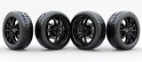 Four black rubber car tires, with silver rims, are neatly lined up in a row on a white background.