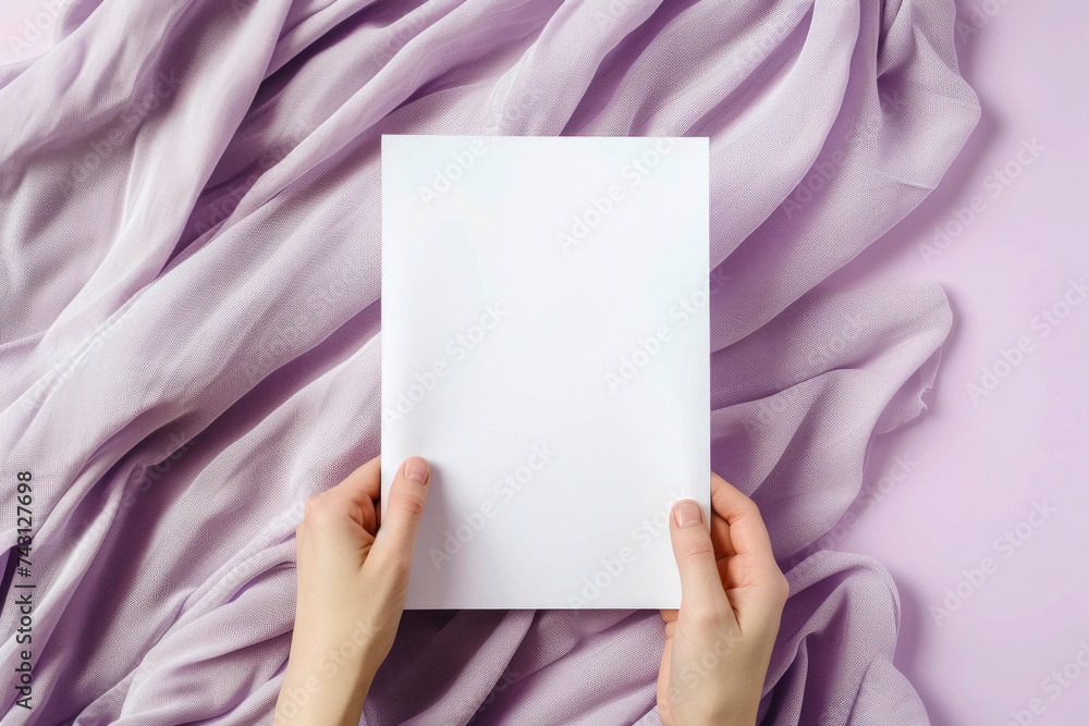 a blank paper mockup. one sheet in the woman hand blank white vertical oriented, on soft violet color background, flatlay. a blank paper mockup. one sheet in the woman hand blank white vertical oriented, on soft violet color background, flatlay.