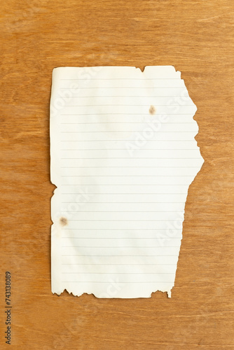 Old empty sheet of paper on a wooden background