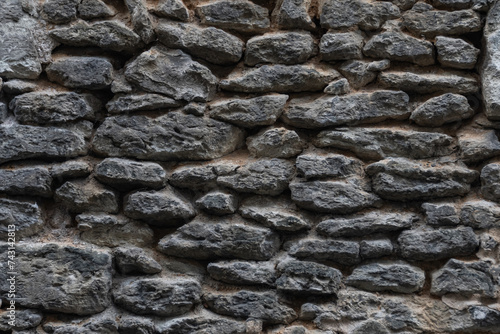 Fragment of an ancient stone wall. Close-up photo