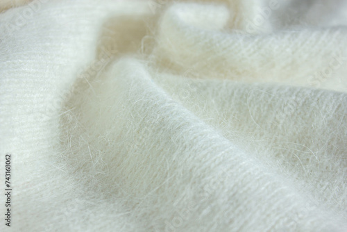 Close up Background texture of white pattern knitted fabric made of Angora or wool. Background fabric texture of Angora. photo