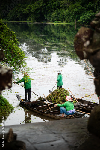 Asiatic female workers doing cleaning Job in tomle om gate photo