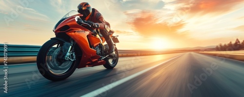 Motorbike rider in sunset light riding with high speed photo