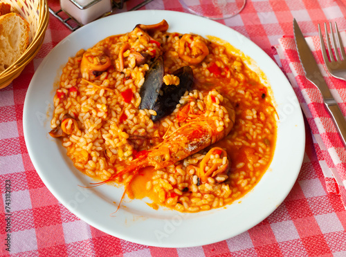 Appetizing racy seafood paella with mussels and prawns.Traditional Valencian cuisine