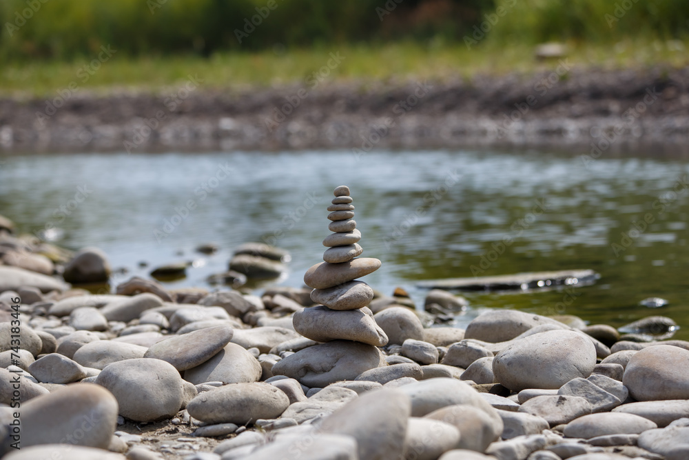 Amazing round stone near a flowing river, Stones are perfectly balanced on one another and forming, These are river stones, or also buddha stones