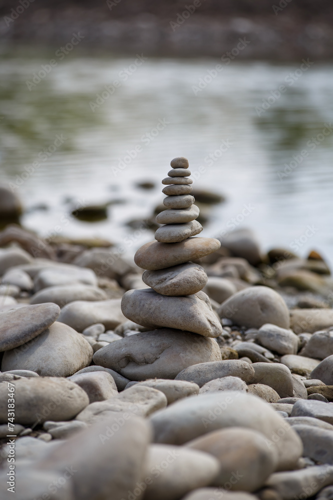 Amazing round stone near a flowing river, Stones are perfectly balanced on one another and forming, These are river stones, or also buddha stones